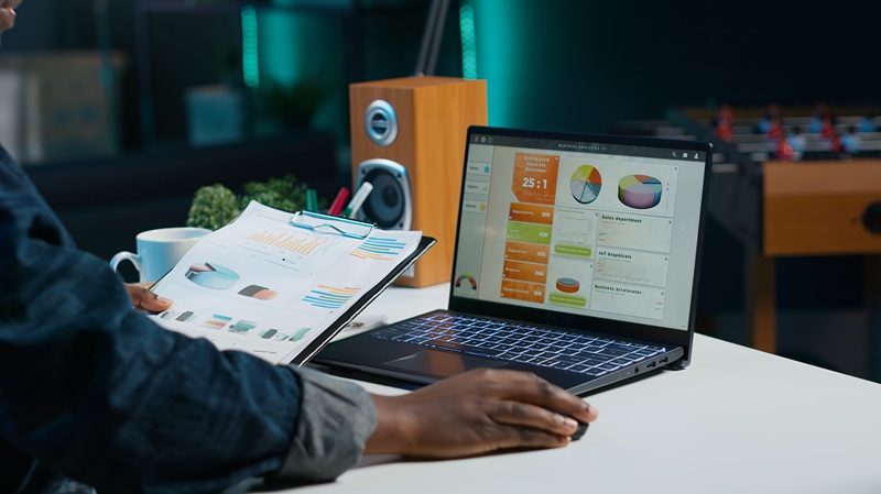 woman sitting at home office desk, looking at business documents